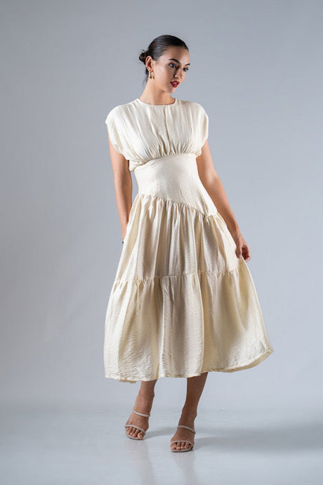 Woman wearing a white dress against a gray background